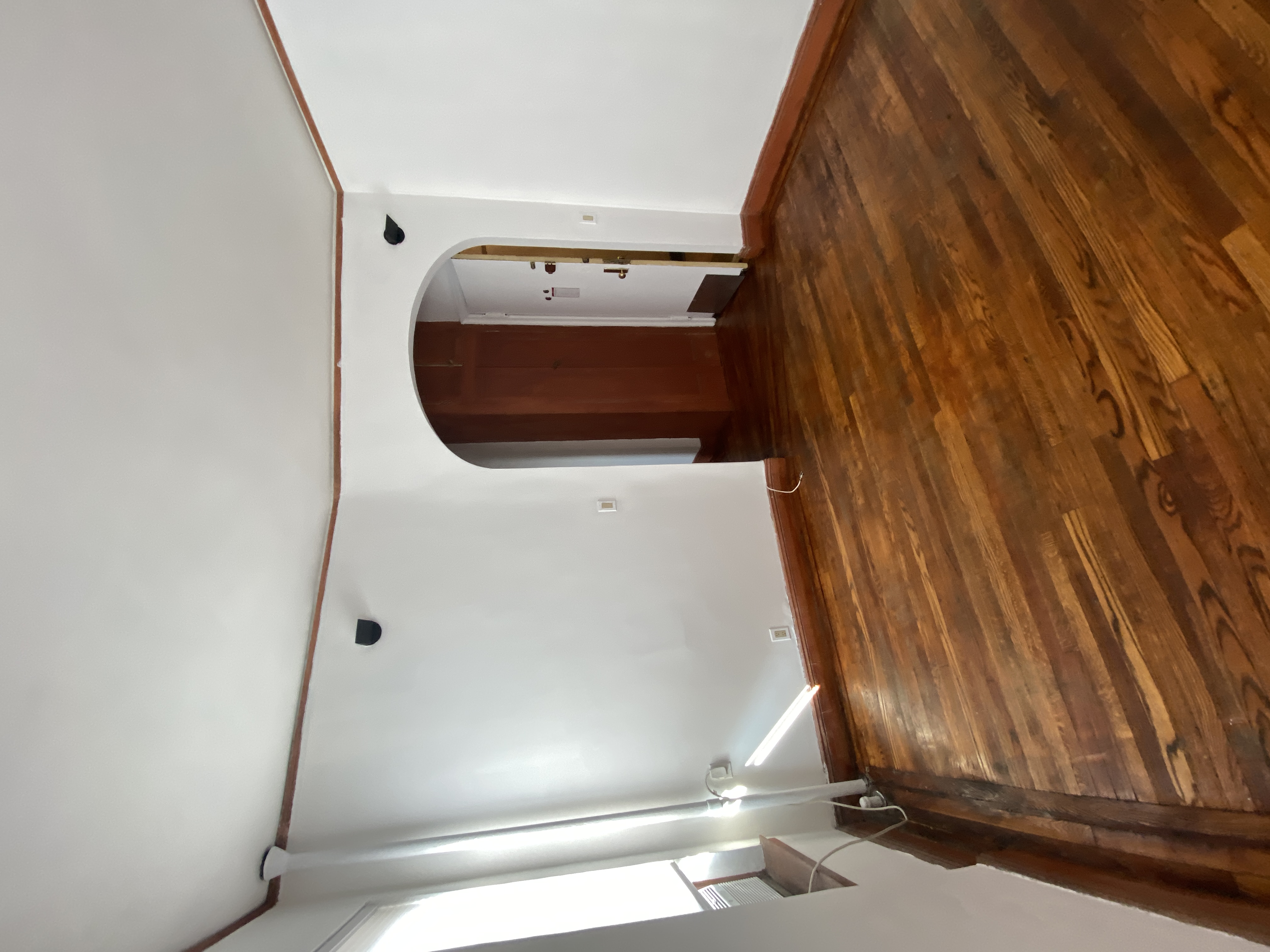 94 Hamilton Place, Unit 5E Manhattan, NY 10031 - Photo 7 of 13 a view of empty room with wooden floor