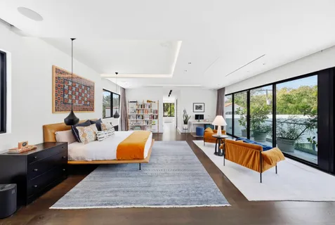 a living room with furniture and a floor to ceiling window