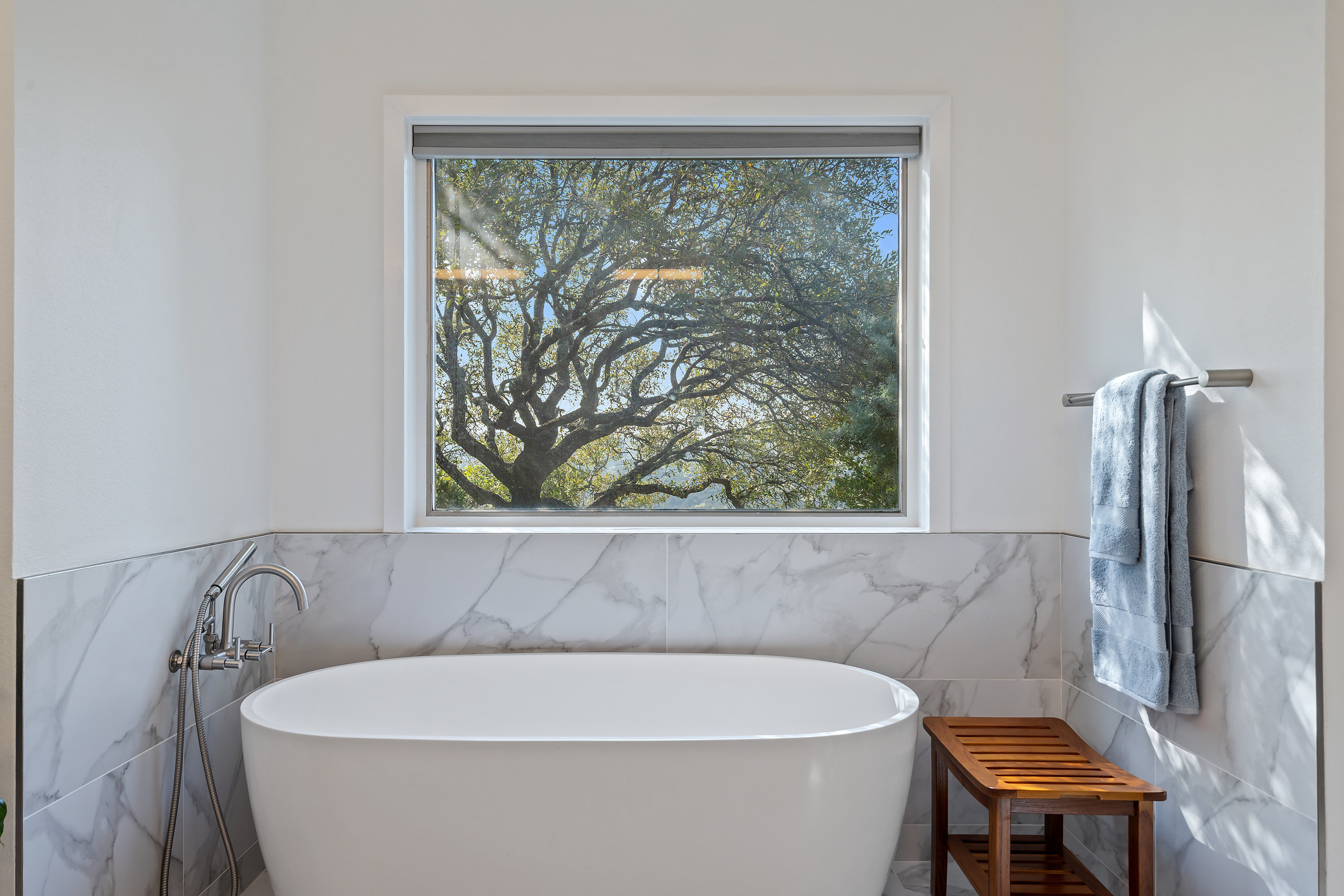 5319 Backtrail Drive Austin, TX 78731 - Photo 27 of 35 a white bath tub sitting in a bathroom next to a window