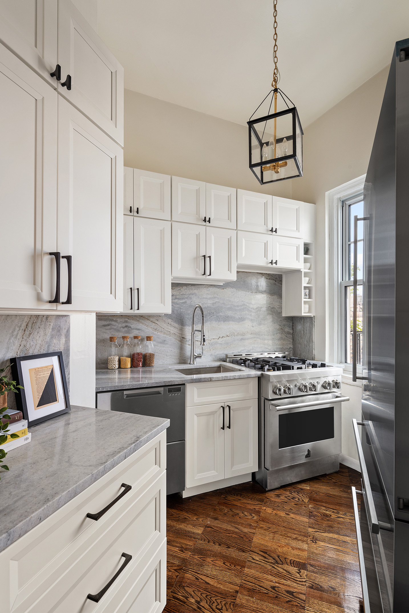 302 West 12th Street, Unit PHE Manhattan, NY 10014 - Photo 10 of 16 a kitchen with stainless steel appliances granite countertop a stove and white cabinets