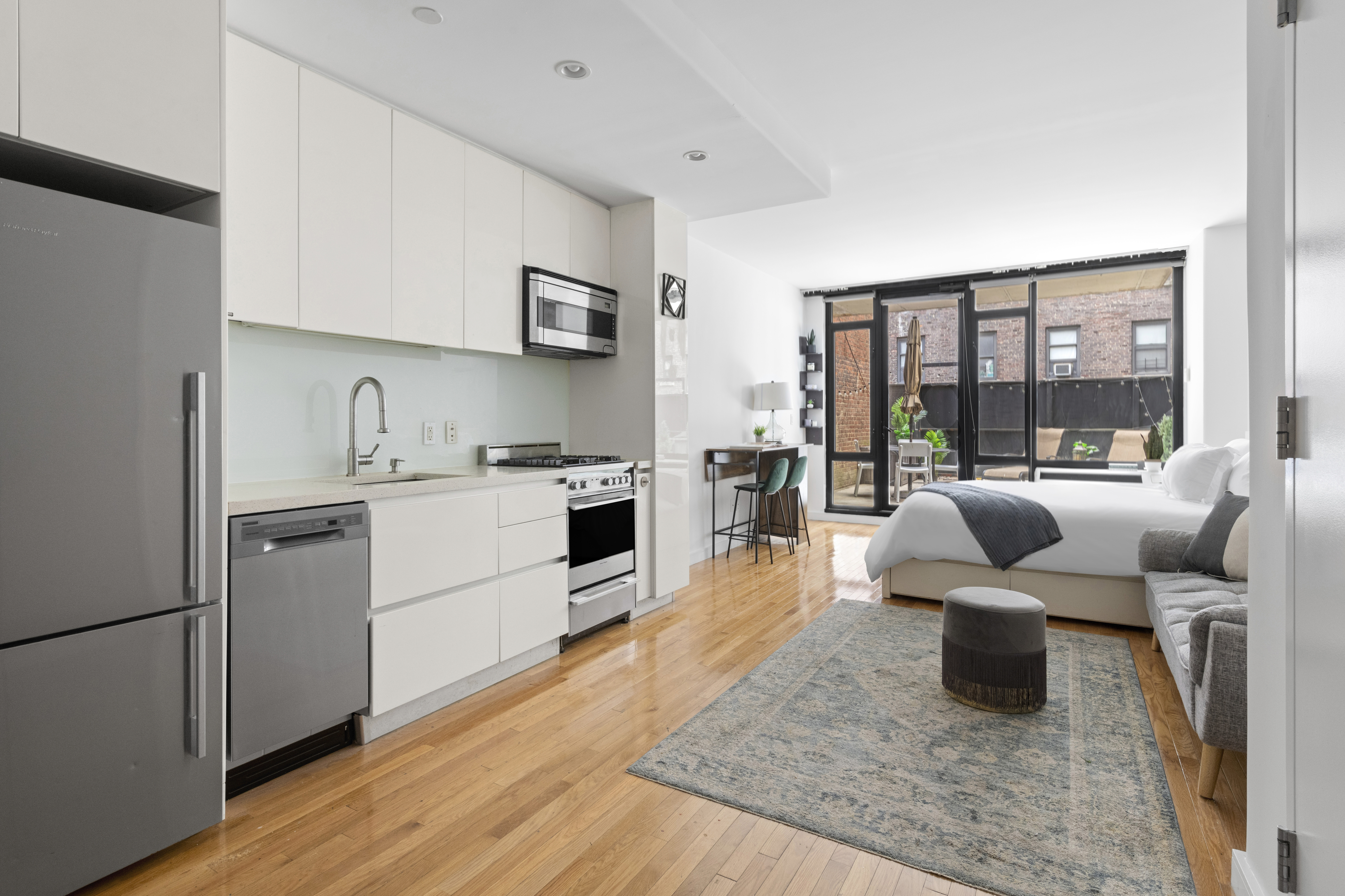 a living room with furniture and a kitchen view