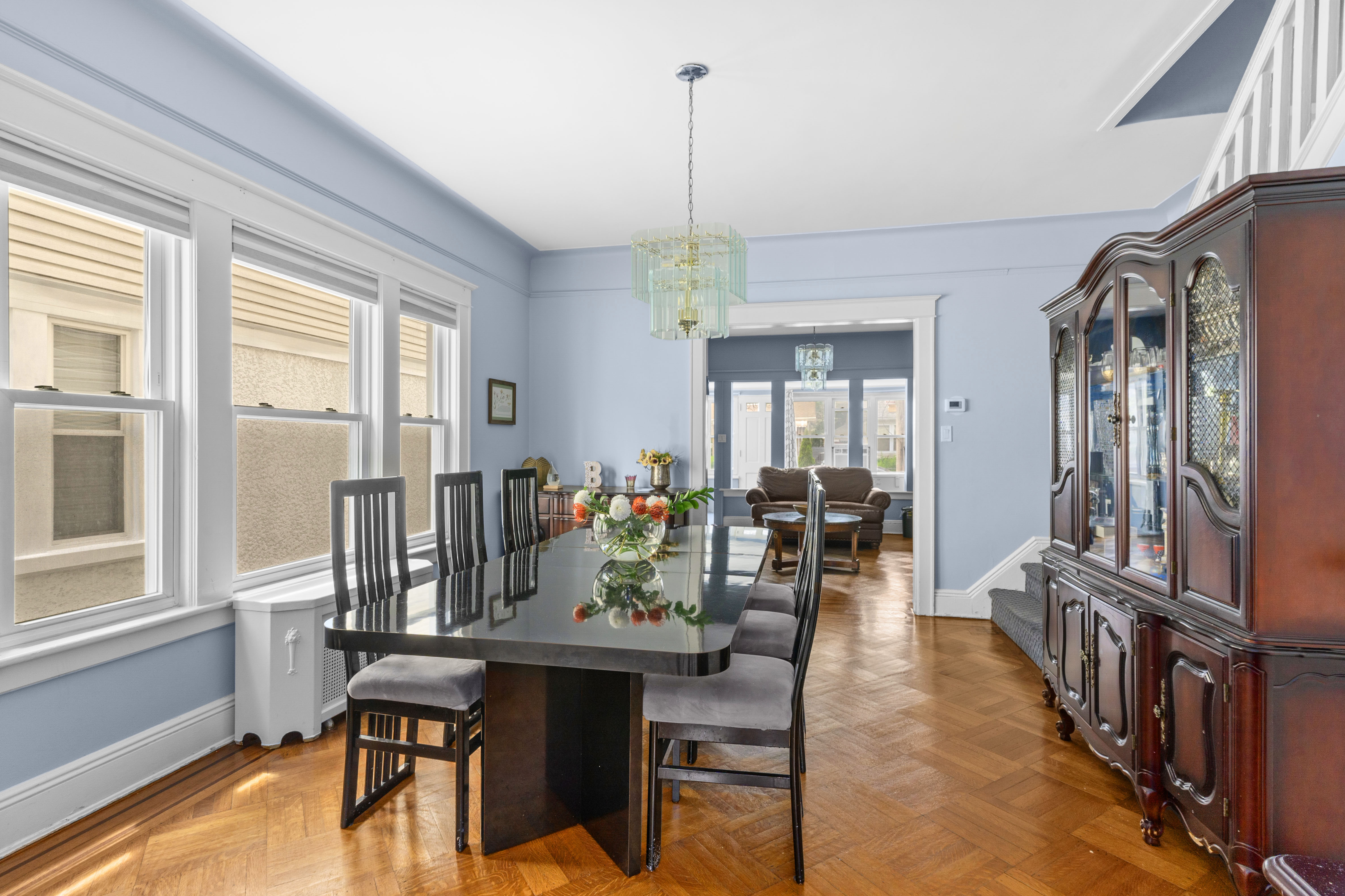 1065 East 39th Street Brooklyn, NY 11210 - Photo 2 of 15 a dining room with furniture a chandelier and wooden floor