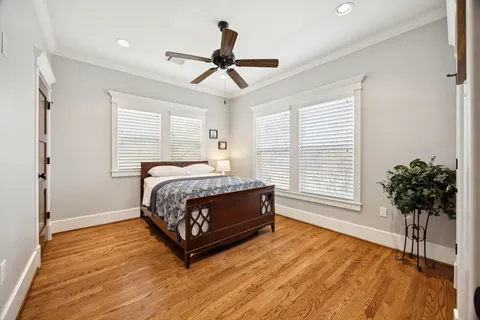 a spacious bedroom with a bed and a potted plant