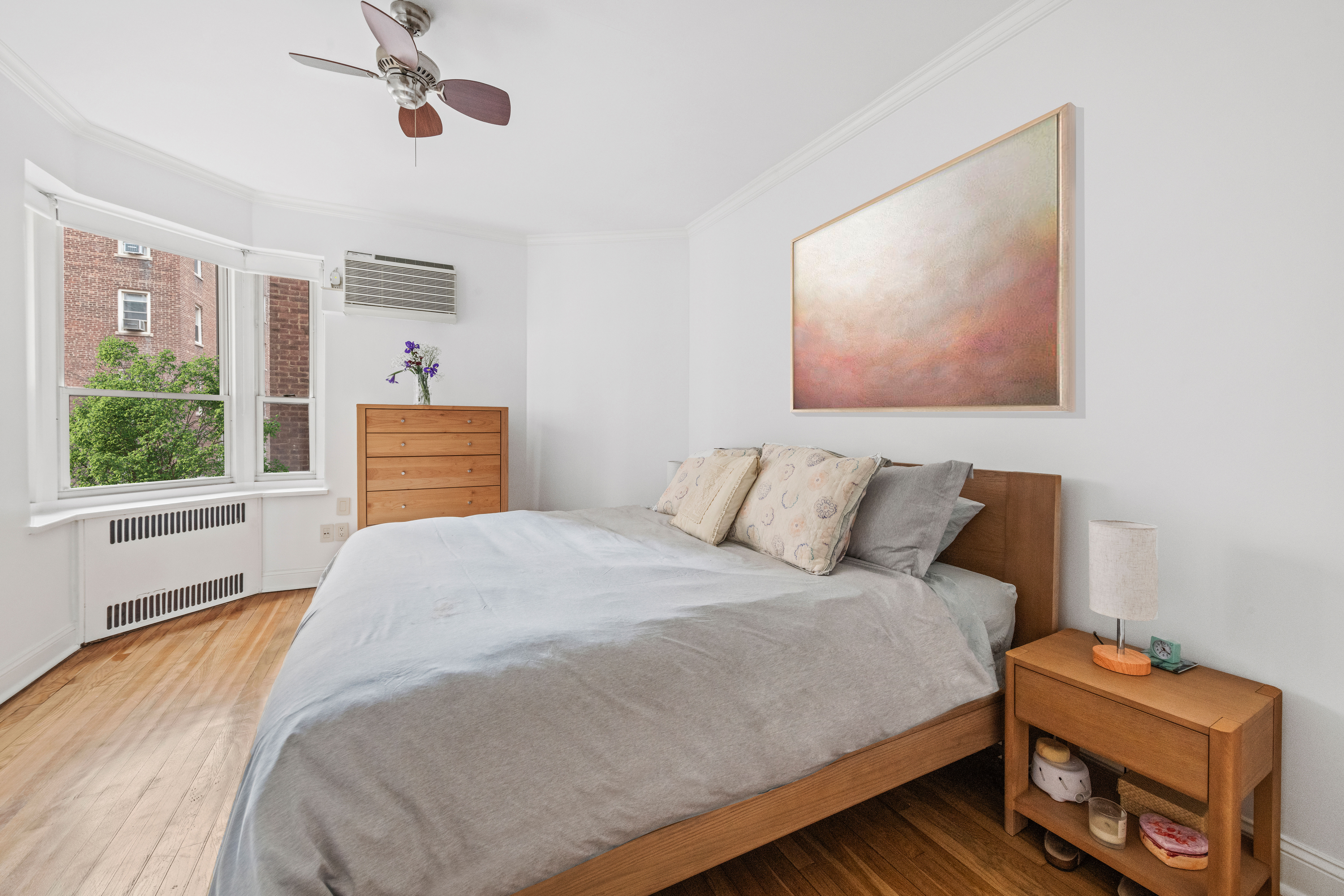525 East 89th Street, Unit 3A Manhattan, NY 10128 - Photo 5 of 11 a bedroom with a bed and wooden floor