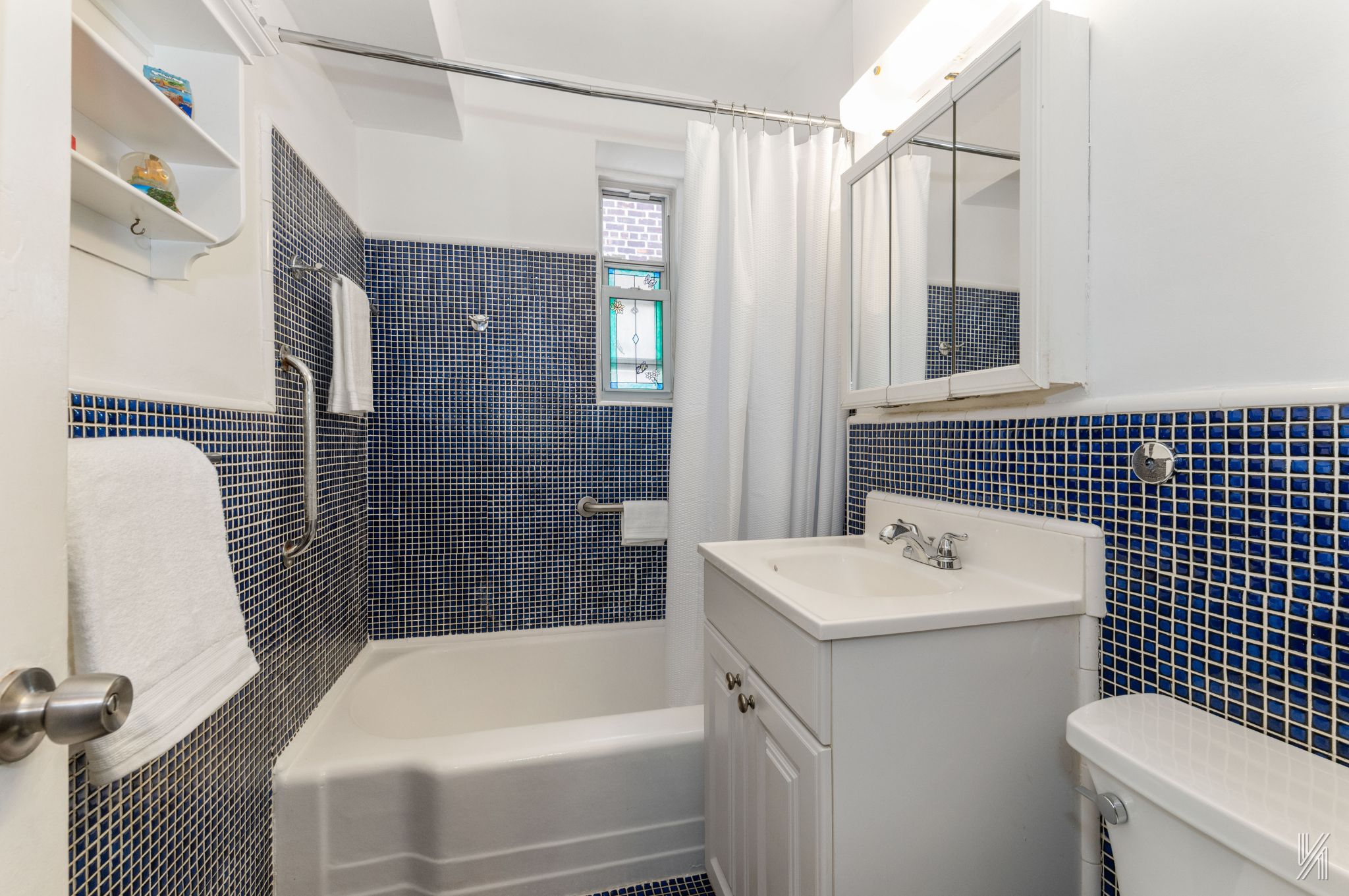 39-30 52nd Street, Unit 5E Queens, NY 11377 - Photo 12 of 15 a bathroom with a sink a toilet and shower