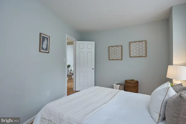 a bedroom with a bed and a lamp on table