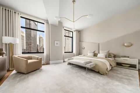 a spacious bedroom with a bed and a couch