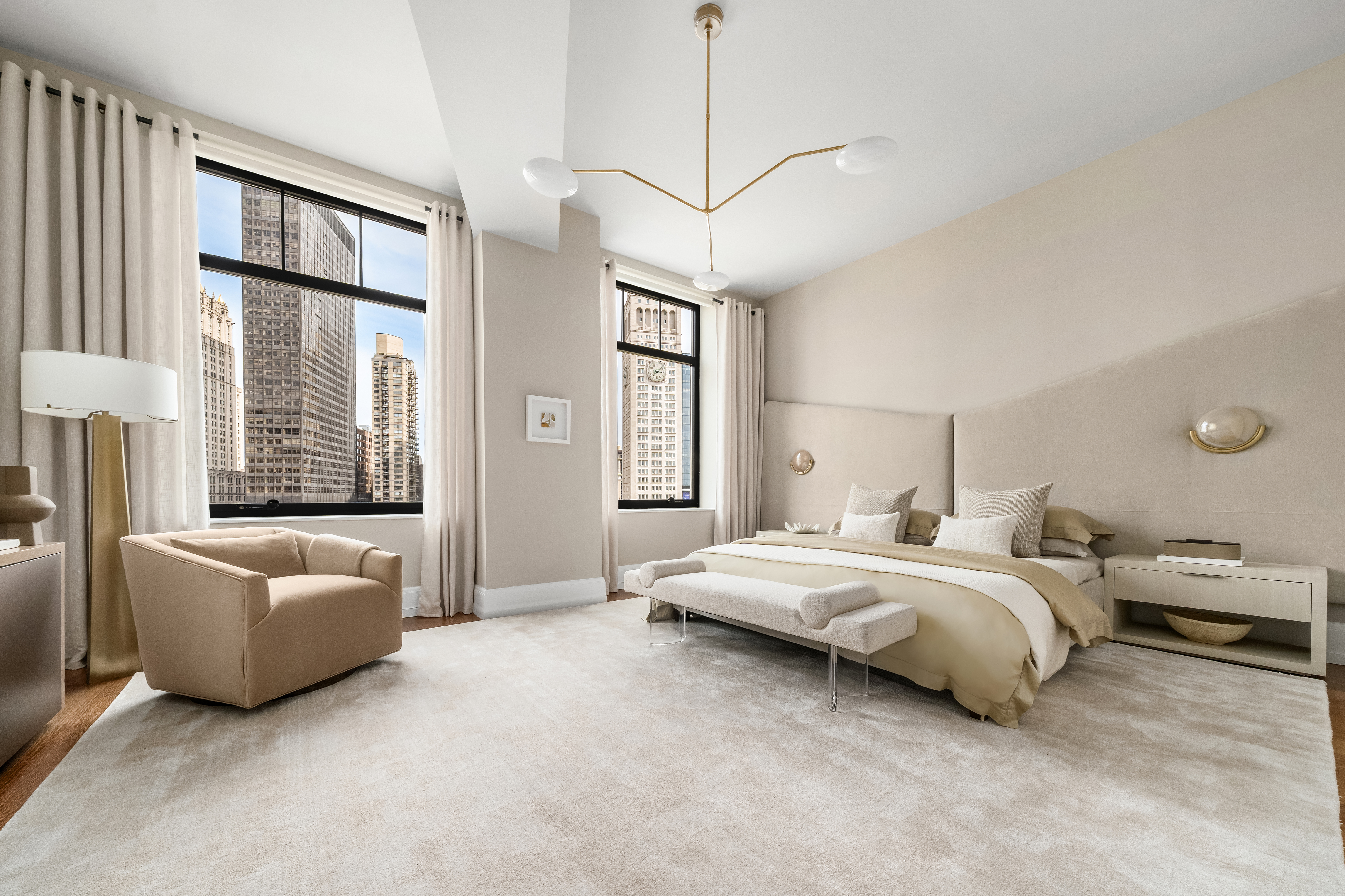 10 Madison Square West, Unit 12D Manhattan, NY 10010 - Photo 10 of 21 a spacious bedroom with a bed and a couch