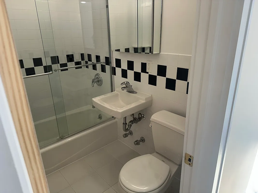 752 Greenwich Street, Unit 1A/B Manhattan, NY 10014 - Photo 5 of 12 a bathroom with a toilet a sink and a shower