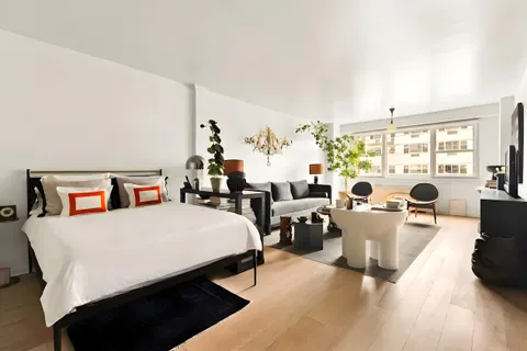 a living room with furniture and a floor to ceiling window