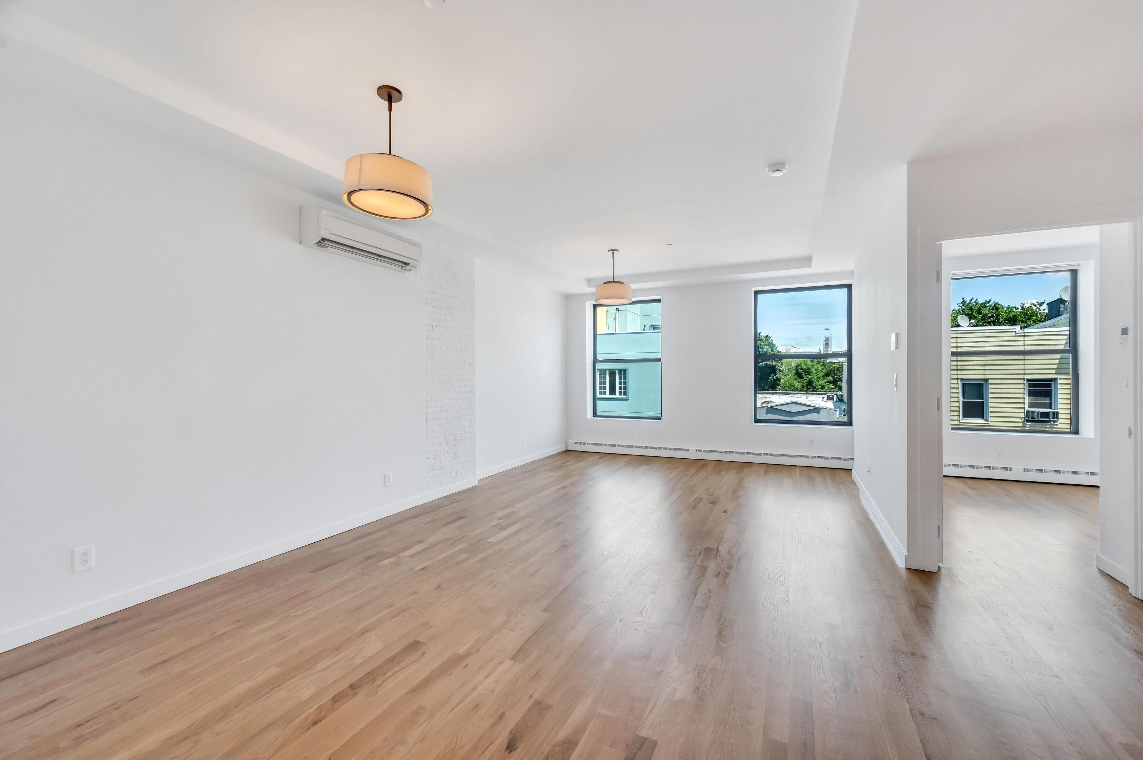 717 Manhattan Avenue, Unit 3A Brooklyn, NY 11222 - Photo 3 of 18 a view of empty room with wooden floor and window