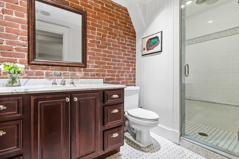 a bathroom with a sink toilet and a mirror