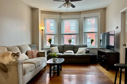 a living room with furniture and a large window