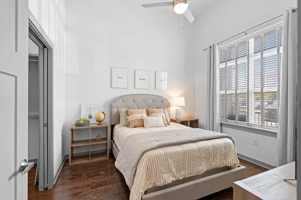 a bedroom with a bed and a window