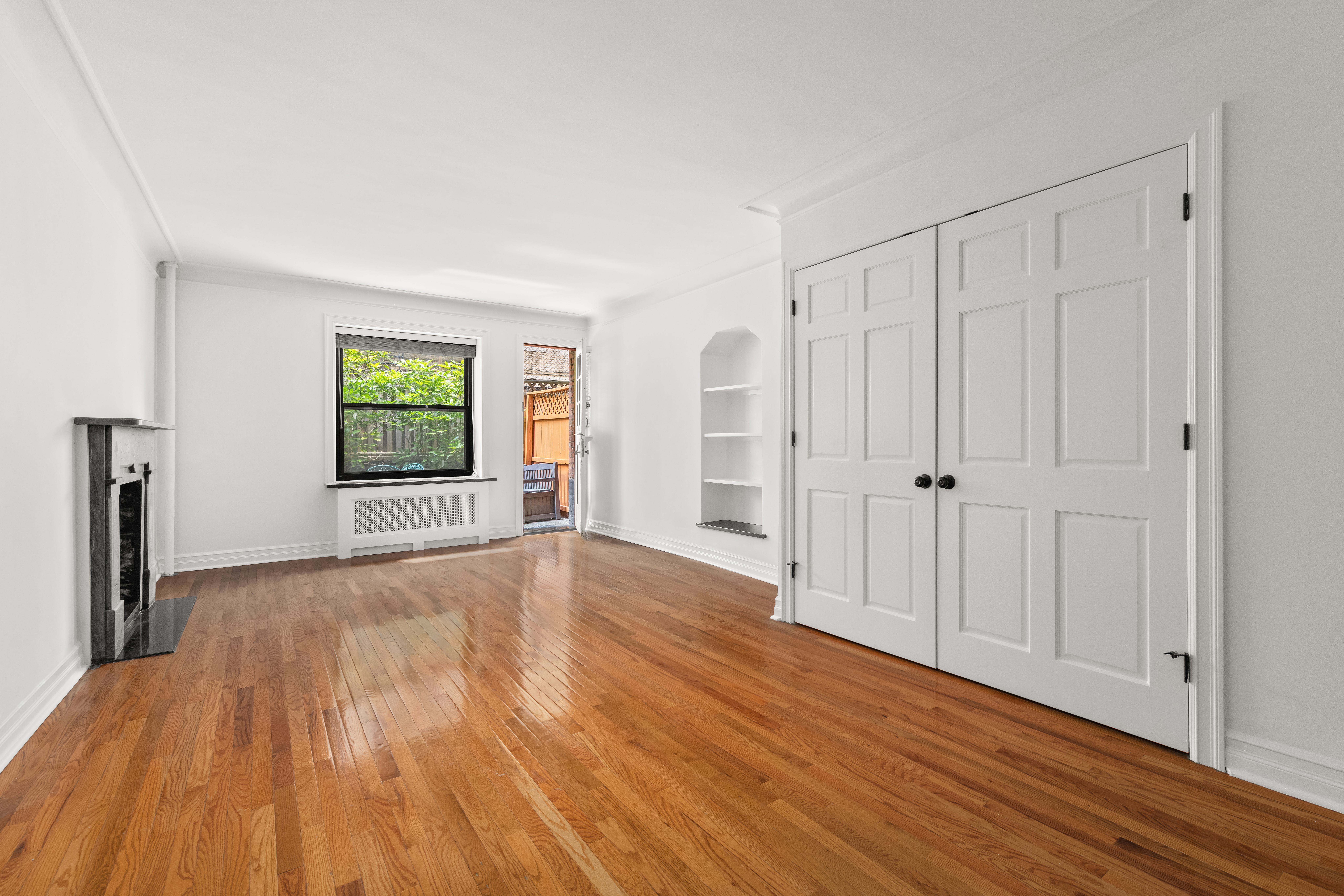 436 East 58th Street, Unit 1C Manhattan, NY 10022 - Photo 6 of 14 a view of an empty room with window and wooden floor