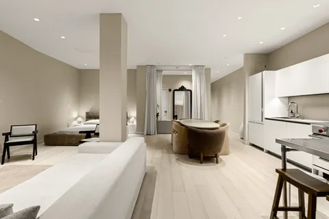 a large bedroom with a bed and a table