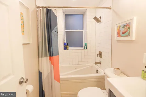 a bathroom with a bathtub and shower