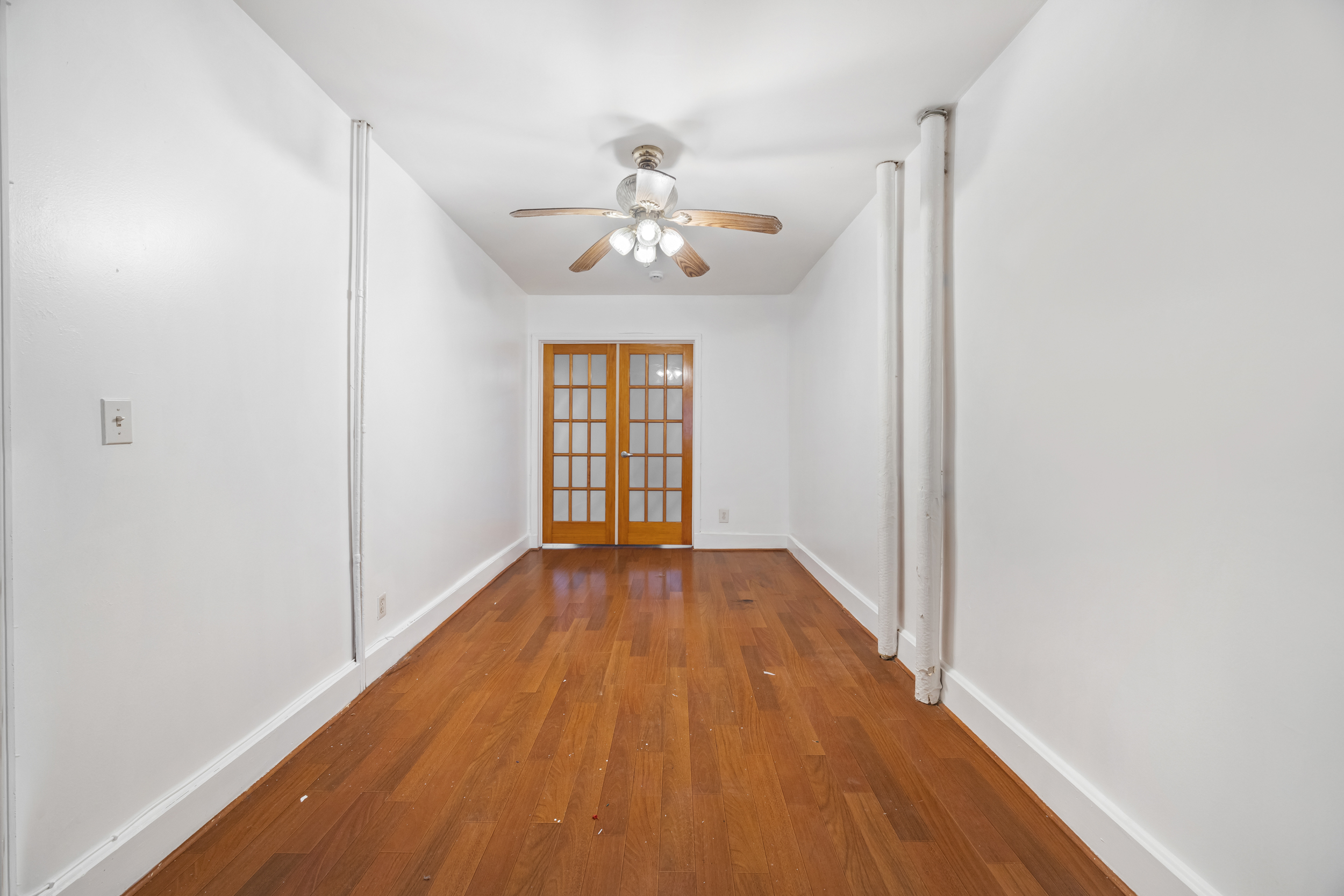 961 Lorimer Street, Unit 2 Brooklyn, NY 11222 - Photo 4 of 5 wooden floor in an empty room with a window