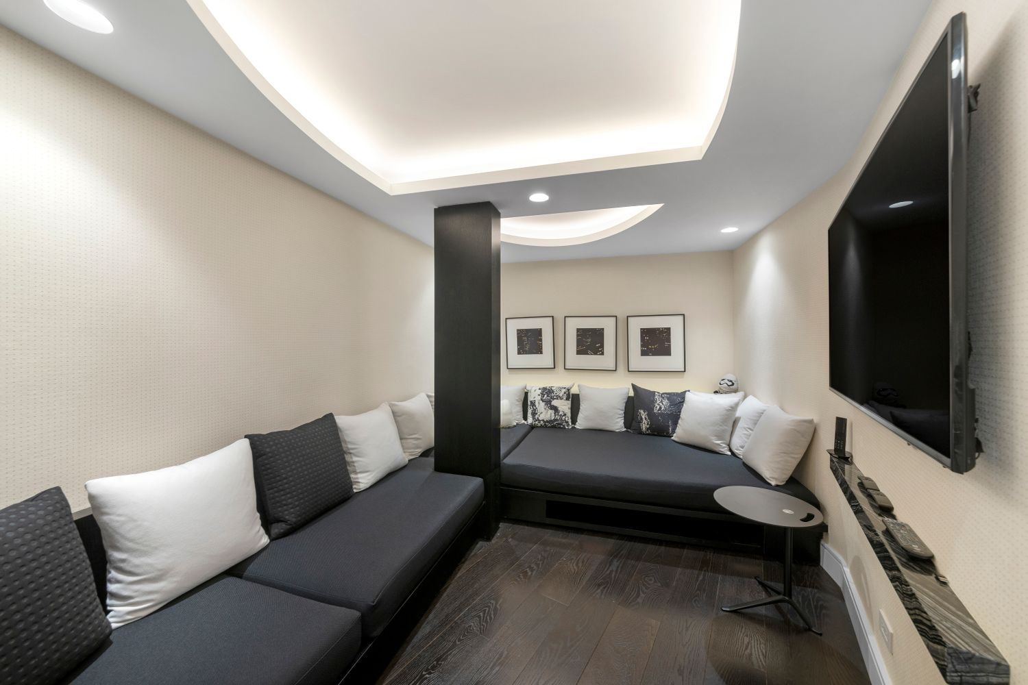 200 Central Park South, Unit 20DEF Manhattan, NY 10019 - Photo 13 of 16 a living room with furniture and a flat screen tv