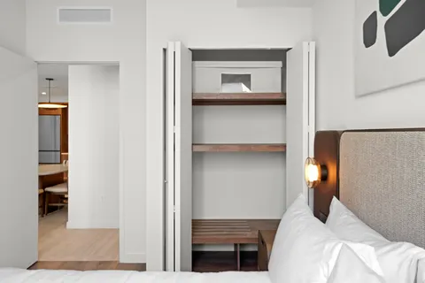 a bedroom with a bed and cabinets