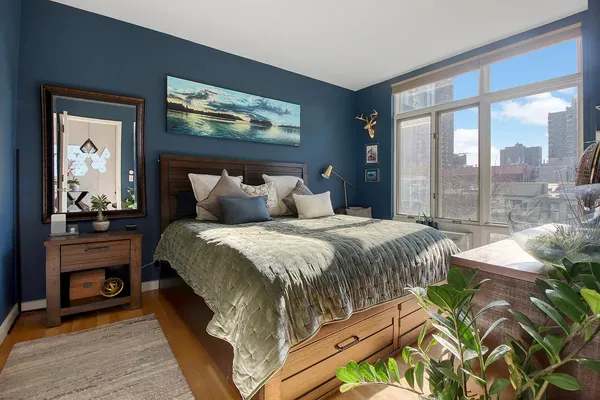 a bedroom with a bed and a large window
