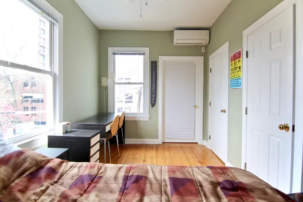 a bedroom with a bed and a window