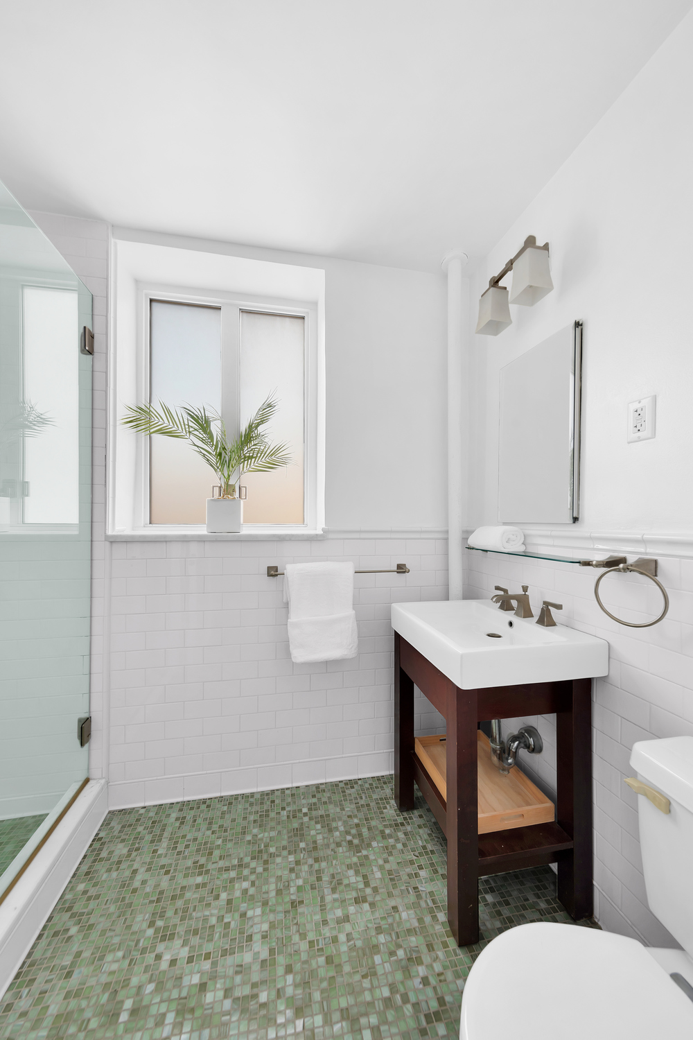 200 West 20th Street, Unit 1110 Manhattan, NY 10011 - Photo 6 of 10 a bathroom with a sink a toilet and window