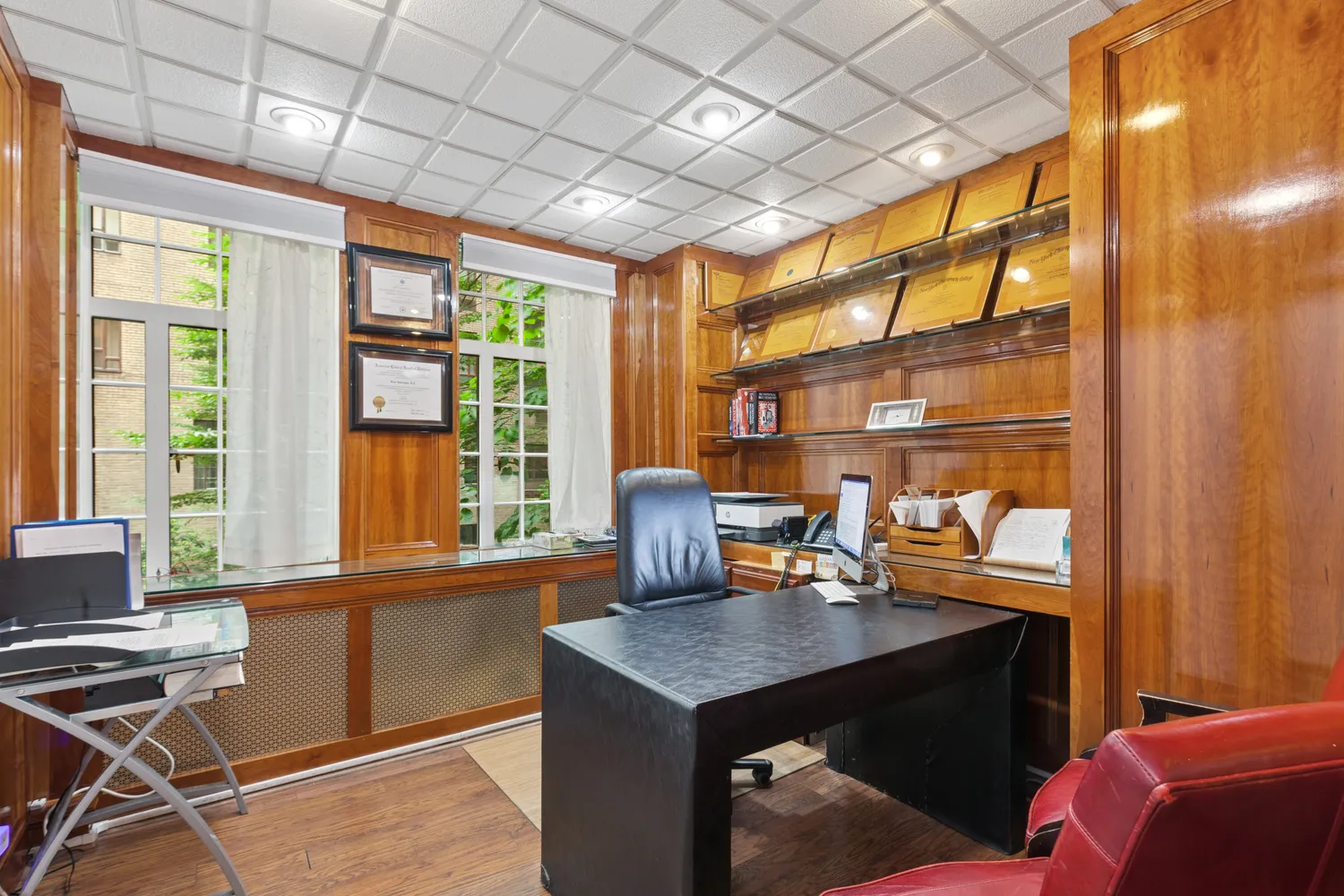 a view of a workspace with furniture and a window