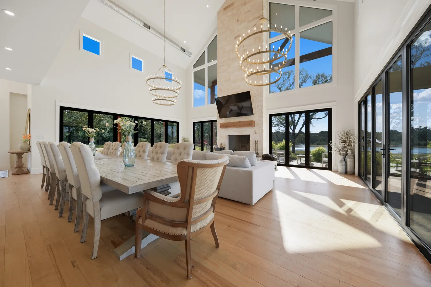 a view of a dining room with furniture a chandelier and wooden floor