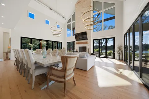 a view of a dining room with furniture a chandelier and wooden floor