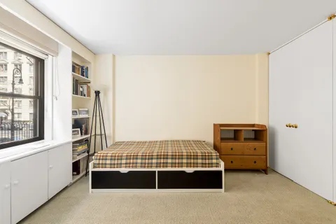 a bedroom with a bed and a window