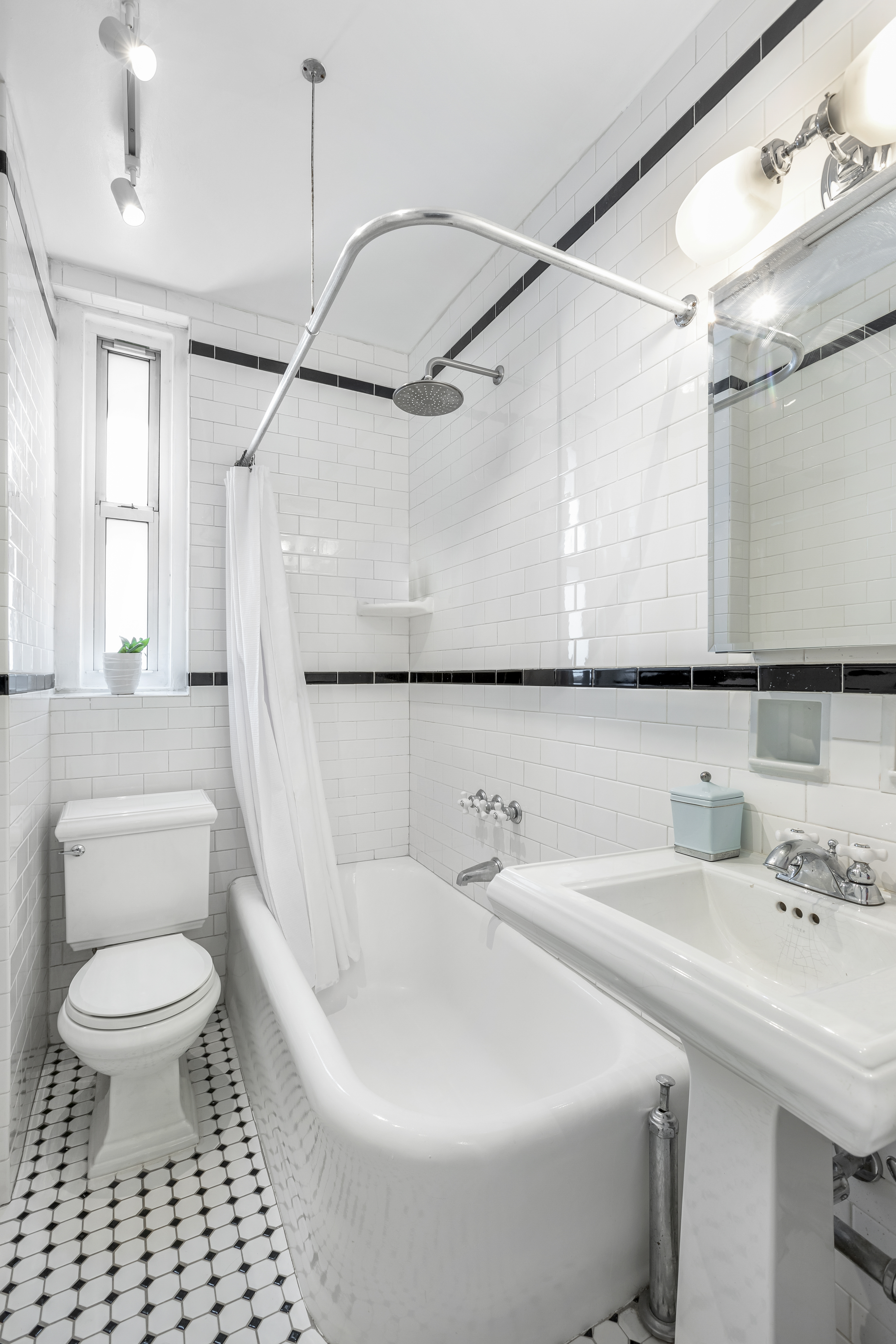 30 Clinton Street, Unit 6A Brooklyn, NY 11201 - Photo 10 of 11 a bathroom with a sink a toilet and shower curtain