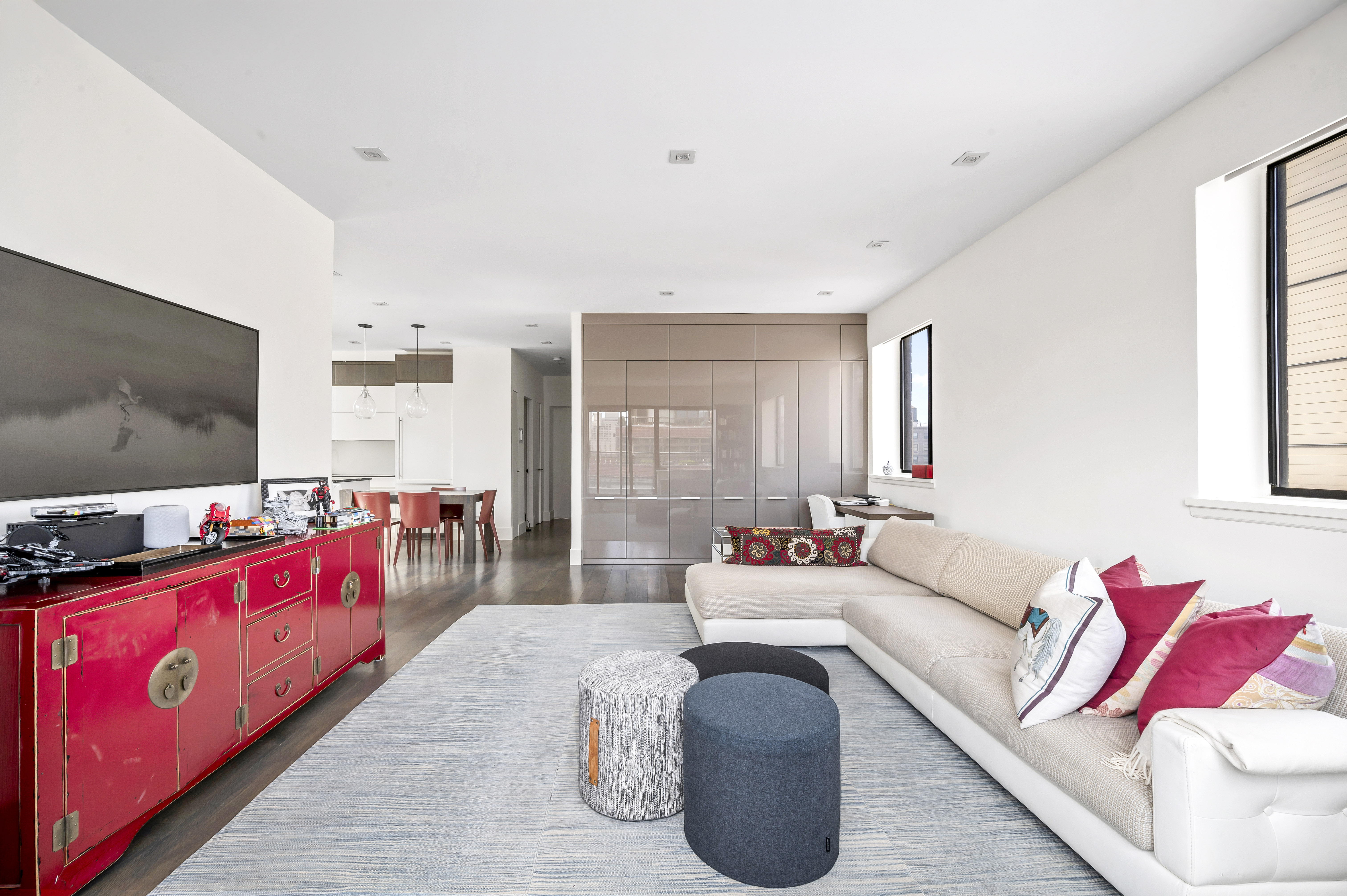 131 East 81st Street, Unit PH15 Manhattan, NY 10028 - Photo 4 of 11 a living room with furniture and a flat screen tv