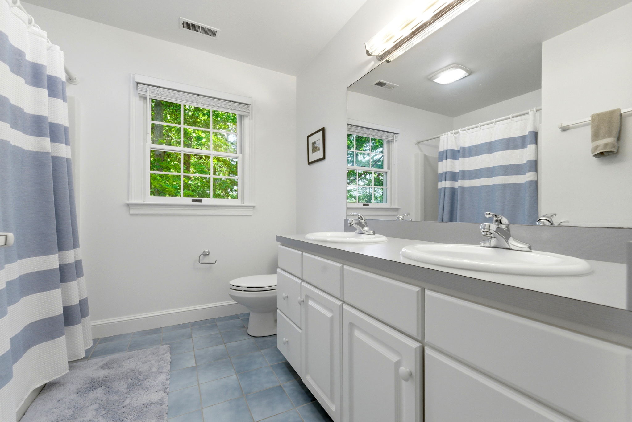 2 Laurel Street Lexington, MA 02421 - Photo 32 of 46 a bathroom with a double vanity sink a toilet and a mirror