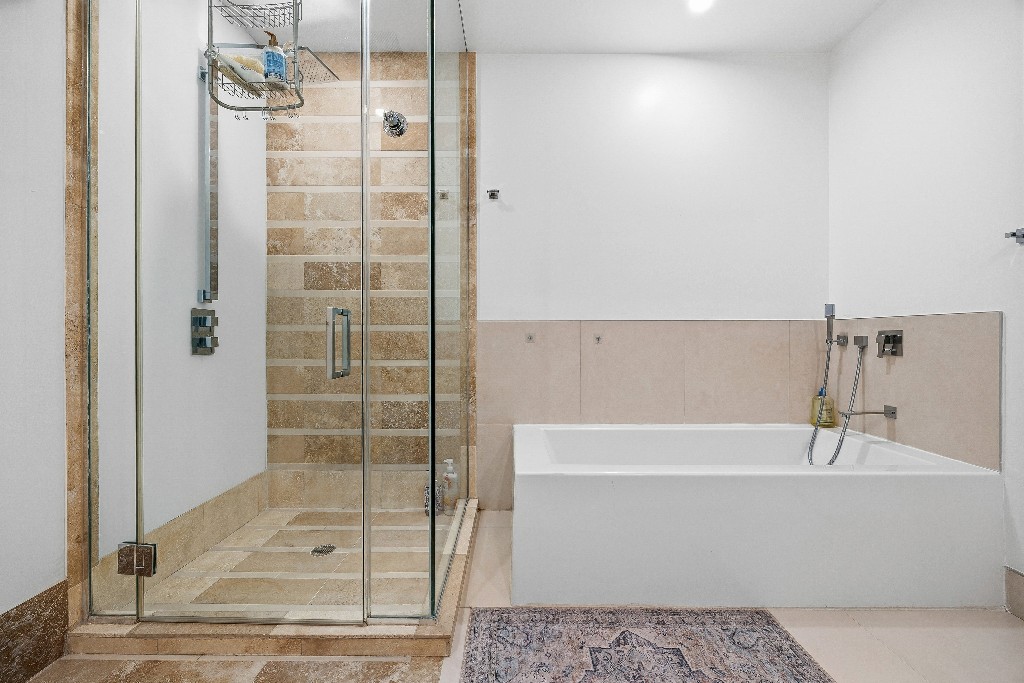 111 Fulton Street, Unit 824 Manhattan, NY 10038 - Photo 22 of 35 a bathroom with a bathtub and shower