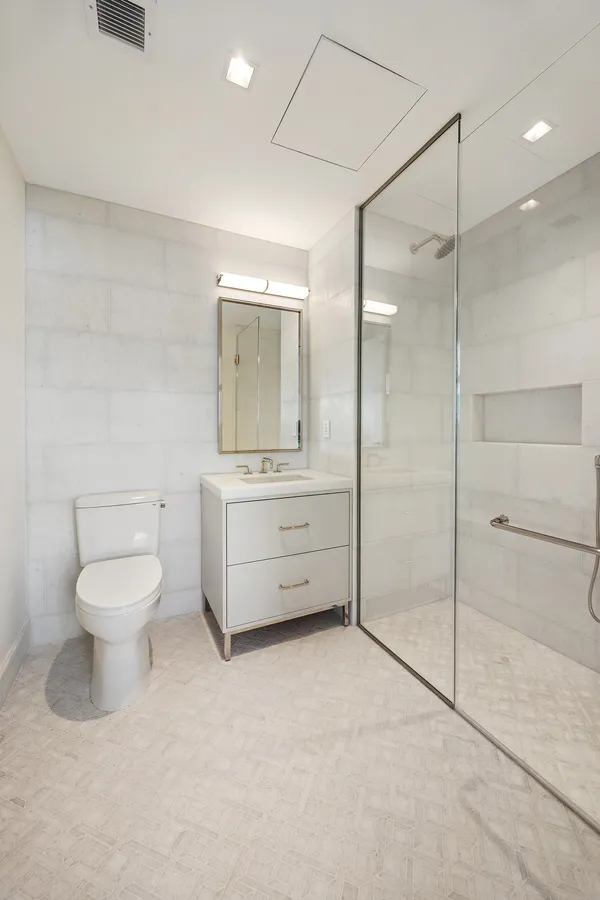 a bathroom with a toilet sink and shower