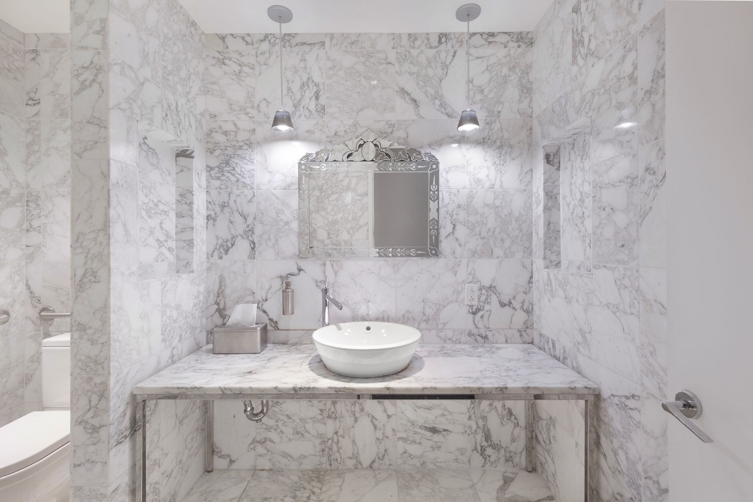 a bathroom with a granite countertop sink a toilet and a shower