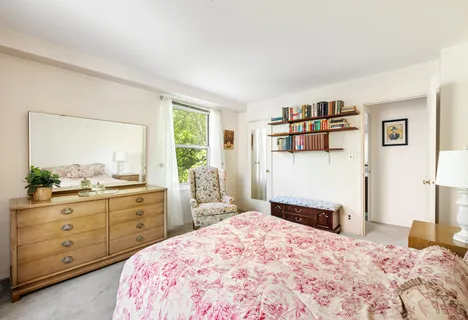 a bedroom with a bed and a dresser in it