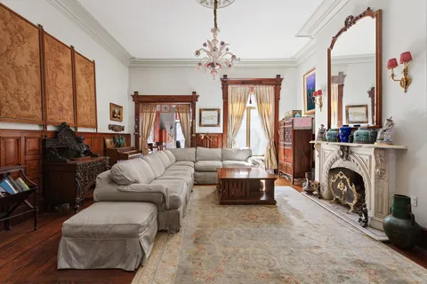 a living room with furniture large window and a fireplace