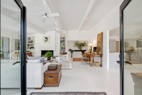 a living room with fireplace furniture and a large window