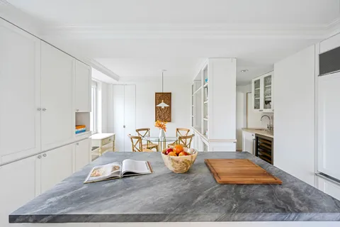 a bed sitting in a spacious bedroom next to a window