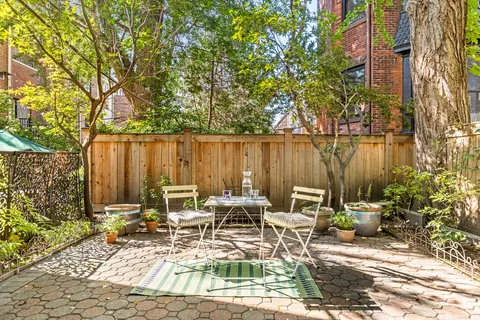 a view of a lake with a table and chairs