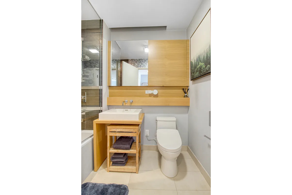 342 East 110th Street, Unit 5E Manhattan, NY 10029 - Photo 10 of 18 a bathroom with a toilet a sink and a mirror