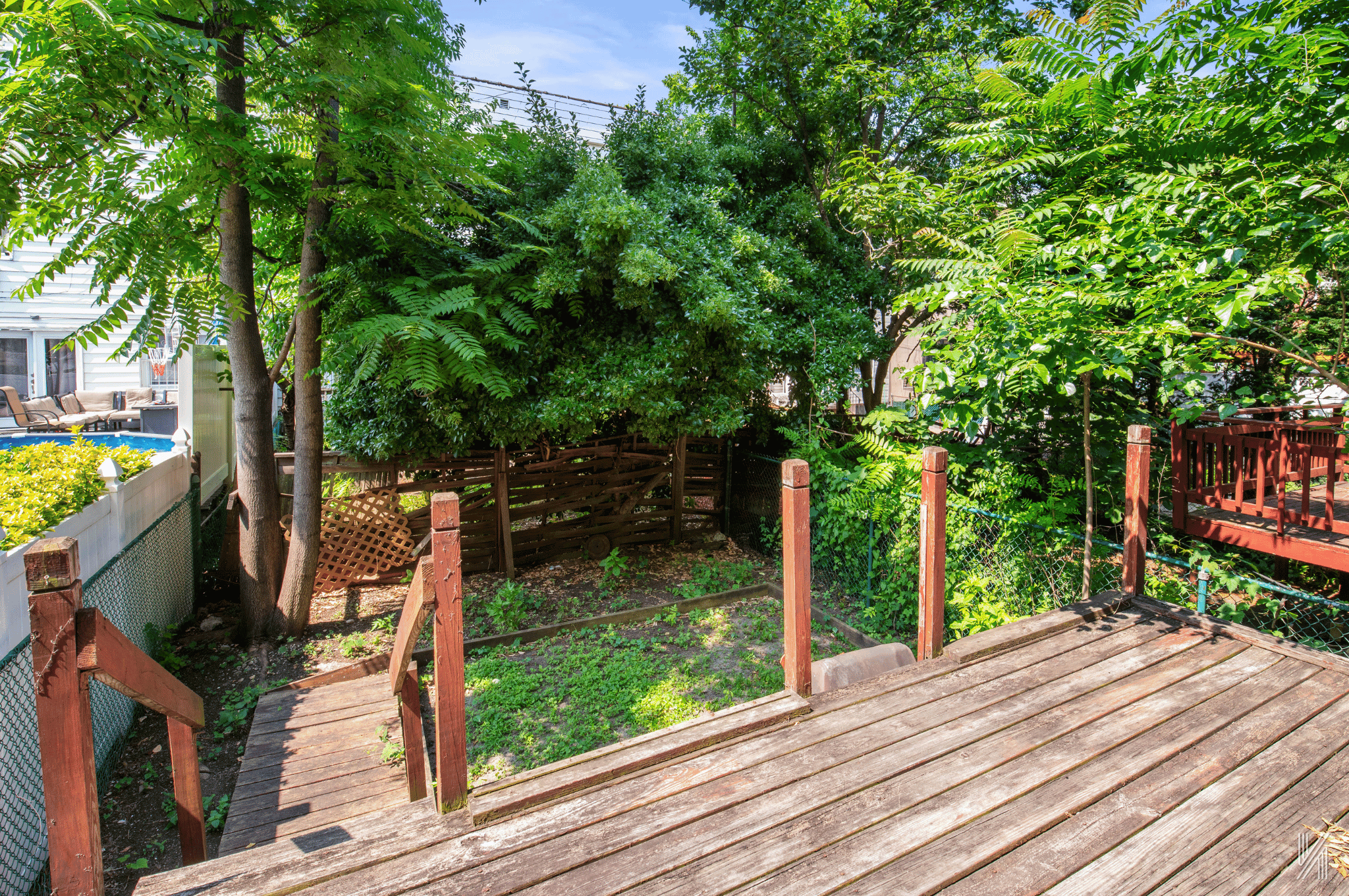 1148 East 73rd Street Brooklyn, NY 11234 - Photo 13 of 15 a view of a deck with chairs a fire pit and a large tree