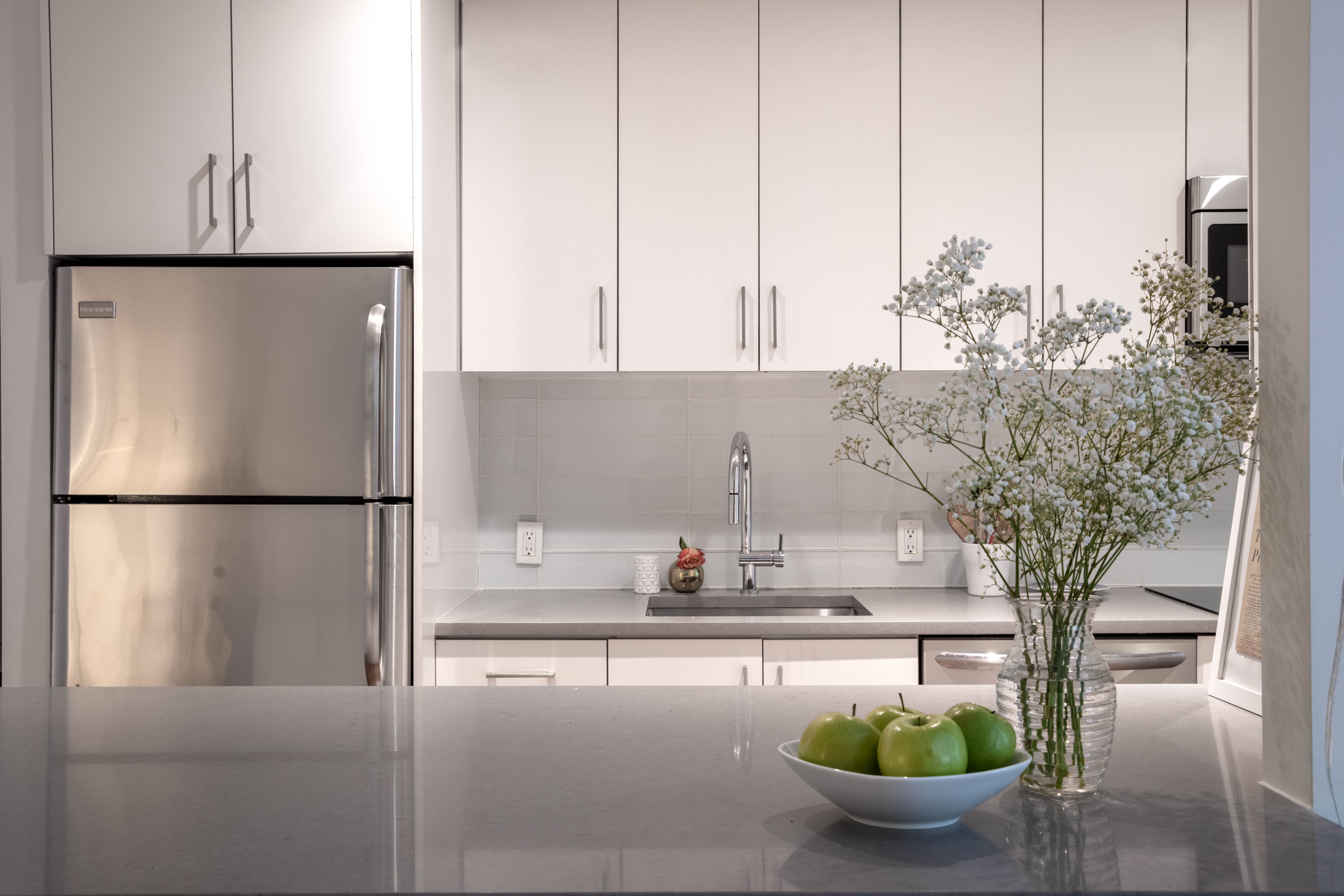 245 West 25th Street, Unit 1L Manhattan, NY 10001 - Photo 2 of 13 a kitchen with a refrigerator and cabinets