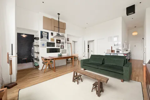 a living room with furniture and a dining table