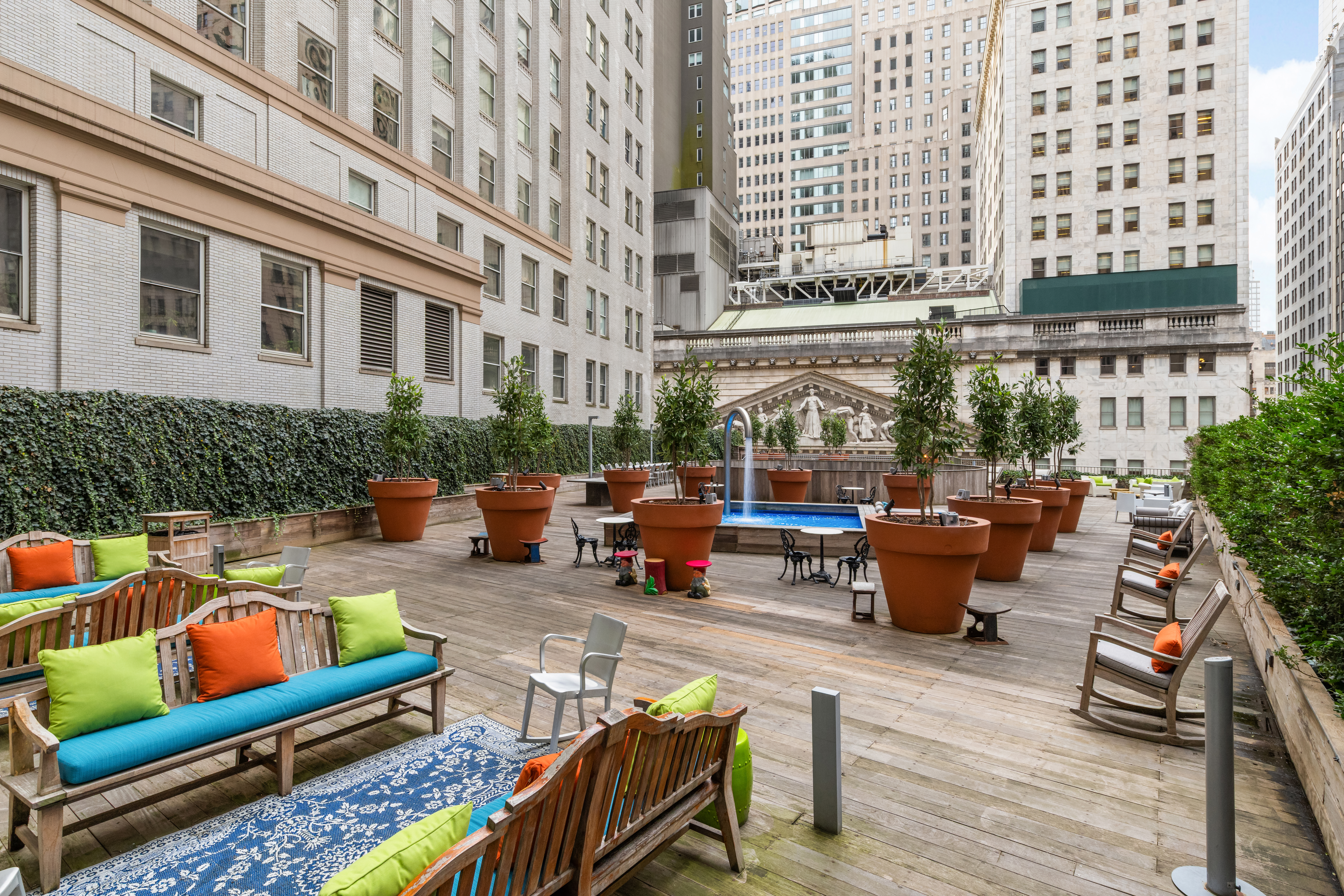 15 Broad Street, Unit 710 Manhattan, NY 10005 - Photo 9 of 11 a view of a patio with couches table and chairs and potted plants