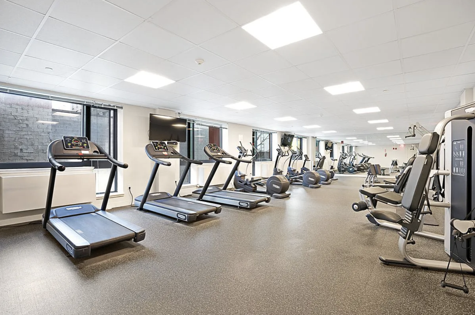 26-14 Jackson Avenue, Unit 9C Queens, NY 11101 - Photo 4 of 8 a view of a room with gym equipment