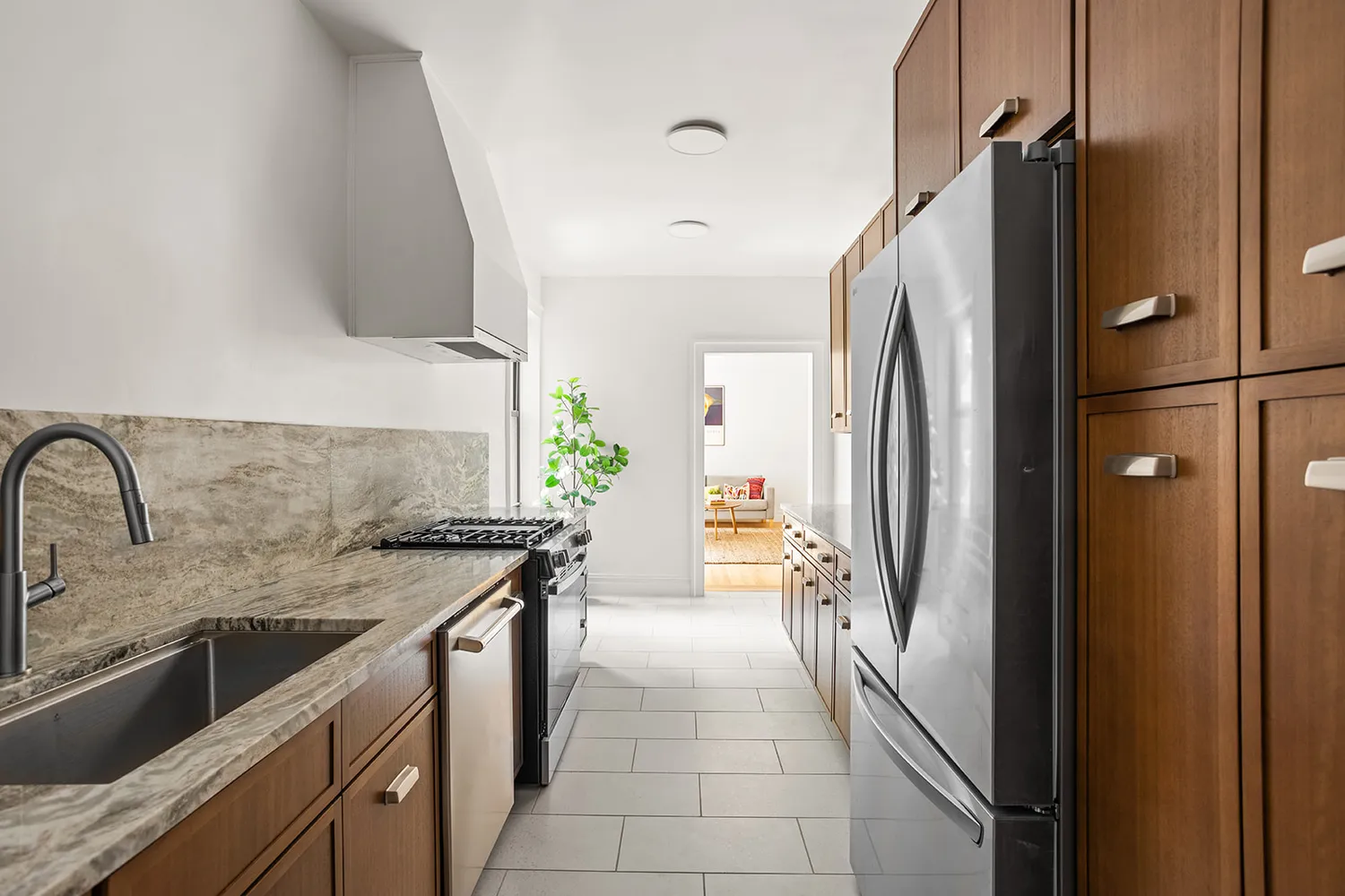 a kitchen with stainless steel appliances granite countertop a refrigerator and a sink