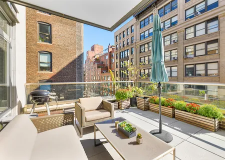 a view of a patio with couches table and chairs and potted plants